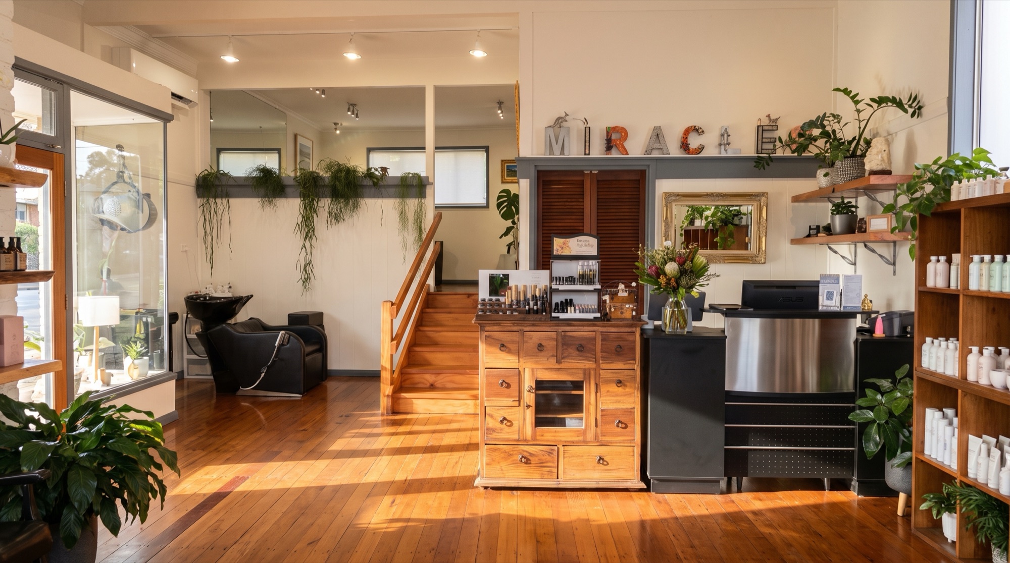Sunlight across the timber floors and botanical-filled reception at Miracles by the Sea
